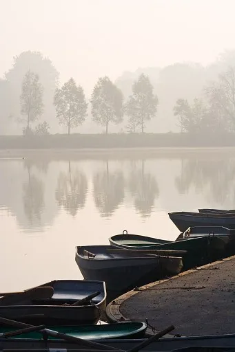 Rowing boats on the lakeside in a misty morning