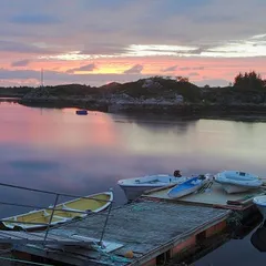 Floating pier with a few boats in twilight