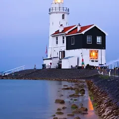 Illuminated lighthouse in twilight
