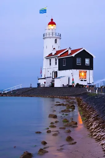 Illuminated lighthouse in twilight